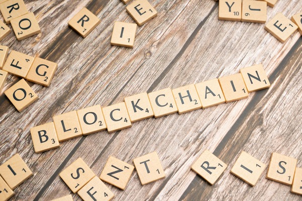Wooden letter tiles spelling blockchain on a table